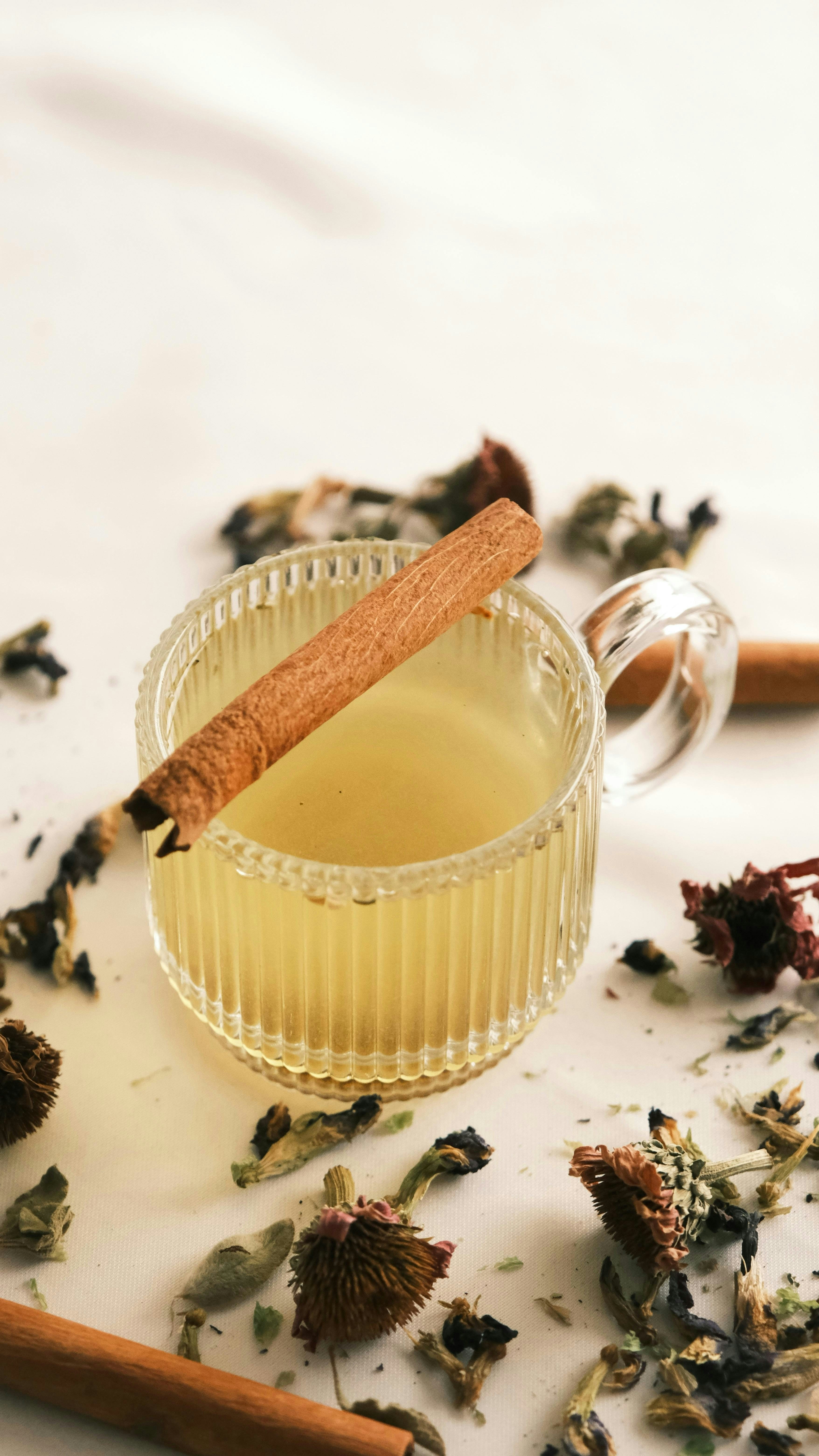 Herbal tisane tea with golden herbs and natural ingredients in a warm setting